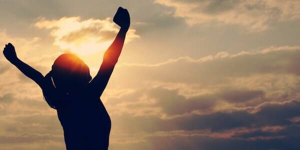 woman arms up high - The Psychology of Self-Confidence and Self-Belief